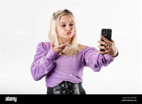 Cute Blonde Woman Wearing Ribbed Blouse Standing Isolated Over White