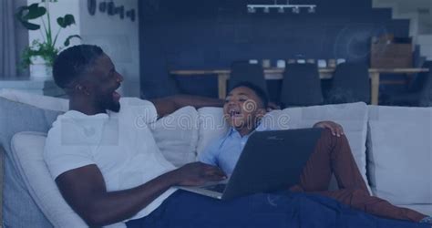 Image Of Data Over Happy African American Father And Son Using Laptop