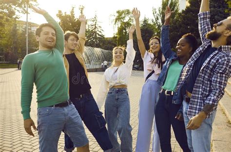 Team Of Cheerful Young Multiracial Friends Stack Hands While Having Fun