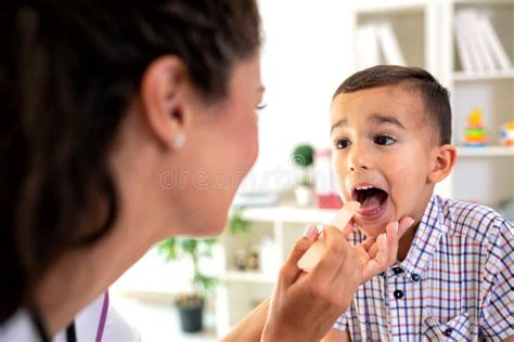 Child Patient With Doctor Showing Tongue Examination Throat Stock