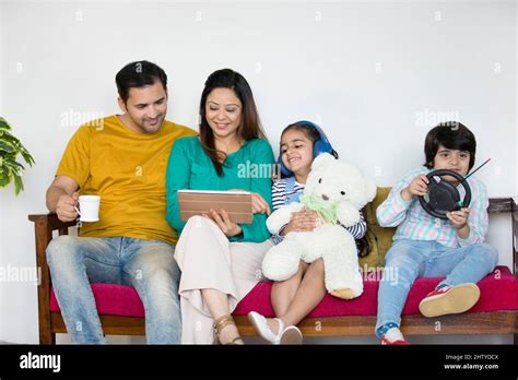 Father and mother playing with their kids at home - Indian boy and girl ...
