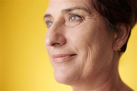 Premium Photo Studio Portrait Of Smiling Mature Woman Looking Away