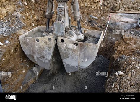 Liquid Concrete Is Poured Into A Foundation Using A Grab Stock Photo