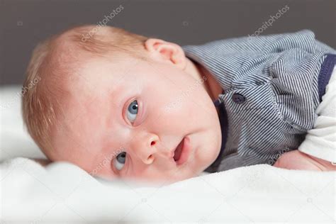Newborn Baby With Blonde Hair And Blue Eyes