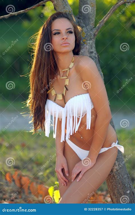 Woman In White Bikini Posing Outdoors Royalty Free Stock Photography