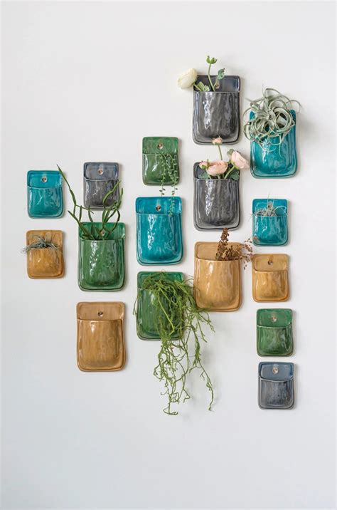 A Wall Display Of Plants In Small Colorful Containers Ceramic Wall