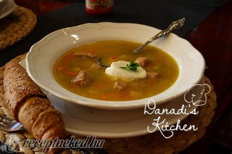 A Bowl Of Soup With Bread On The Side