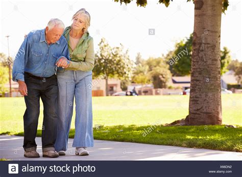 Carer Helping Senior Woman Walk High Resolution Stock Photography And