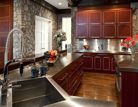 Unique metal countertops surround this kitchen, matching cabine hardware over cherry wood ...