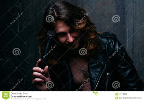 Brutal Man In A Leather Jacket On A Naked Body With Long Hair A Lonely Man Is Sad And Desperate