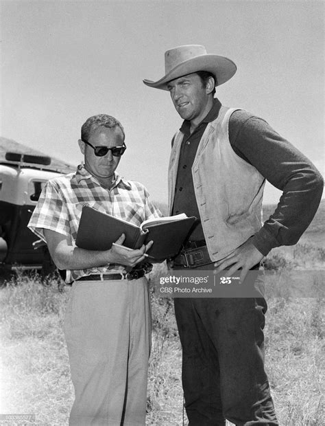 GUNSMOKE. Seymouir Burns directing, left, and James Arness as Marshal...