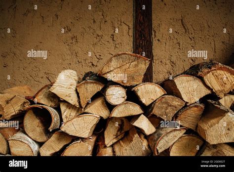 Pile Of Stacked Triangle Firewood Prepared For Fireplace And Boiler