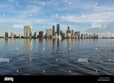 The City Of Miami Skyline And Its Reflection On The Tranquil Water Of