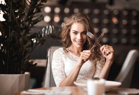 Premium Photo Beautiful Woman Holding Fork And Knife In Restaurant