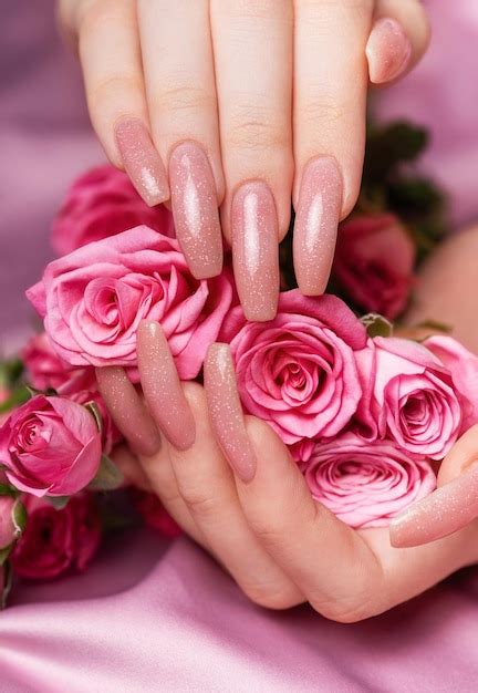 Premium Photo Female Hands With Pink Nail Design Hold Pink Roses