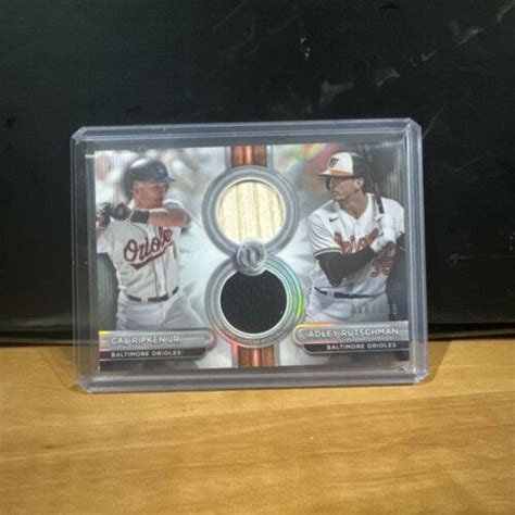 Cal Ripken Jr Adley Rutschman Topps Tribute Dual Jersey Bat Relic