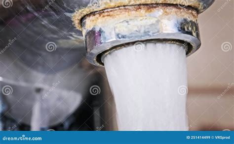 Water Flows From An Old Contaminated Tap With Calcium And Grime Into A