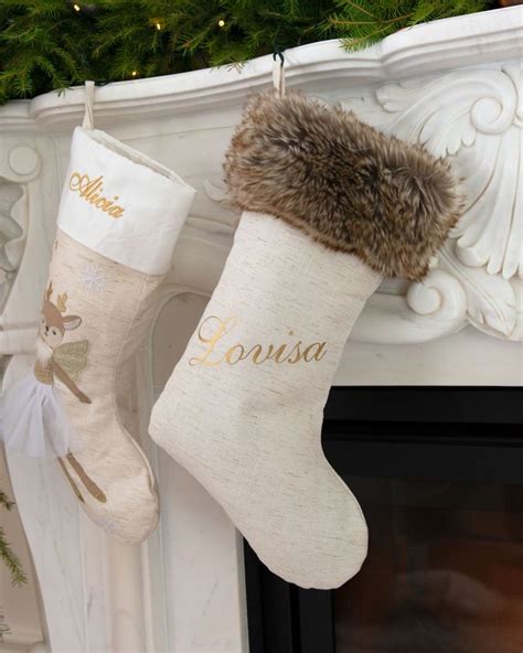 A Christmas Stocking Hanging From A Fireplace Mantel With Personalized