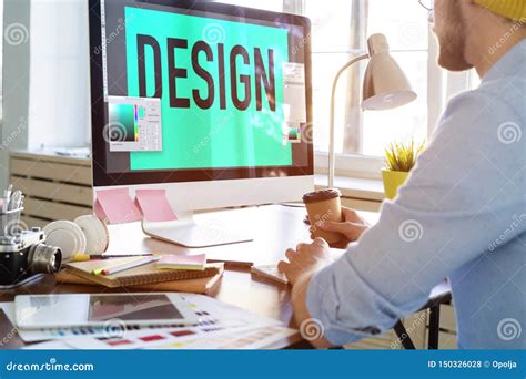 Young Creative Manager Sitting At His Table And Working On Computer