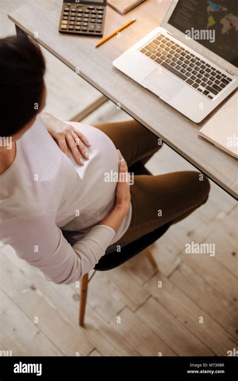 Brunette Pregnant Woman Trying To Concentrate Stock Photo Alamy