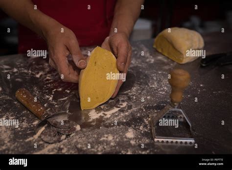 Baker Showing Cutting Piece Of Dough Stock Photo Alamy