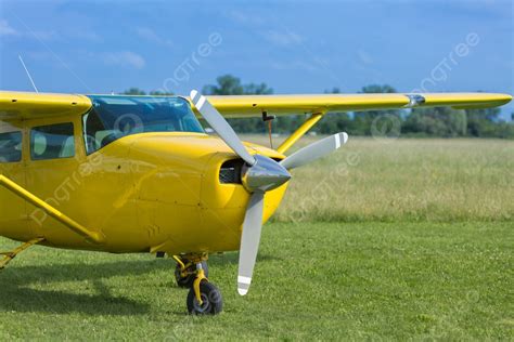 Small And Light Yellow Piper Aircraft Near To The Runaway Photo