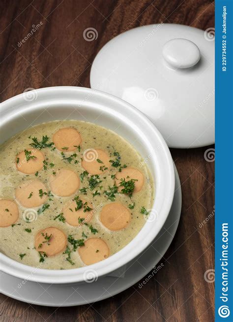 German Traditional Kartoffelsuppe Potato And Sausage Soup On Wood Table