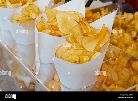 Fried Potato Chips In Paper Cornets For Sell At Market Stall Stock