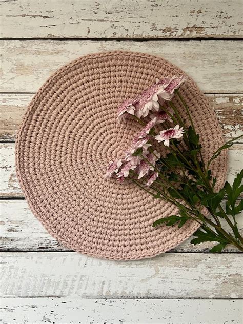 Crochet Circle Table Runner On A Wooden Table With A Transvaal Daisy