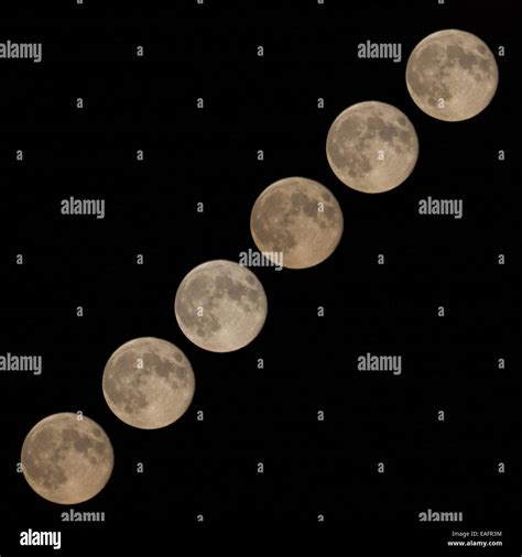 Combination of different phases of rising full moon at black background Stock Photo - Alamy