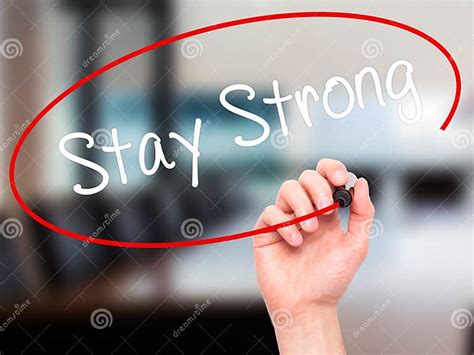 Man Hand Writing Stay Strong With Black Marker On Visual Screen Stock