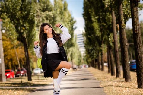 Portrait Of Nice Girl With Brunette Hairdo Wear School Uniform Holding Backpack Back From
