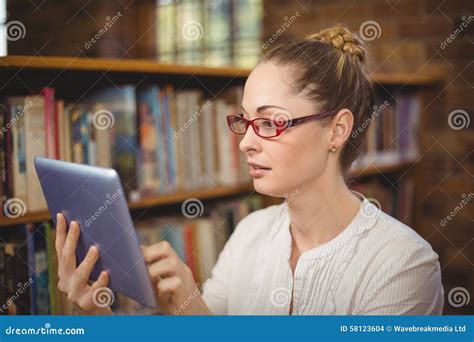 Blonde Teacher Using Tablet In The Library Stock Photo Image Of Serious Class 58123604