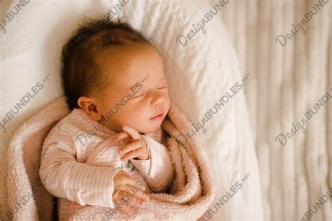 Cute baby girl sleeping in crib wrapped