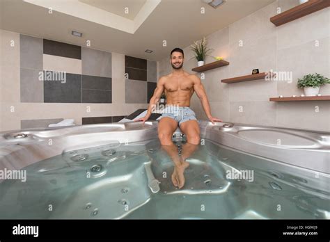 Wellness Spa Man Relaxing In Hot Tub Whirlpool Jacuzzi Indoors At Luxury Resort Spa Retreat
