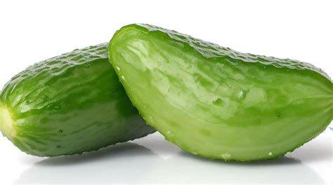 Premium AI Image Two Fresh Green Cucumbers Isolated On White Background