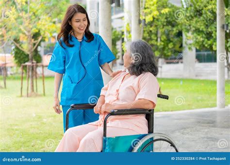 Asian Careful Caregiver Or Nurse Hold The Patient Hand And Encourage