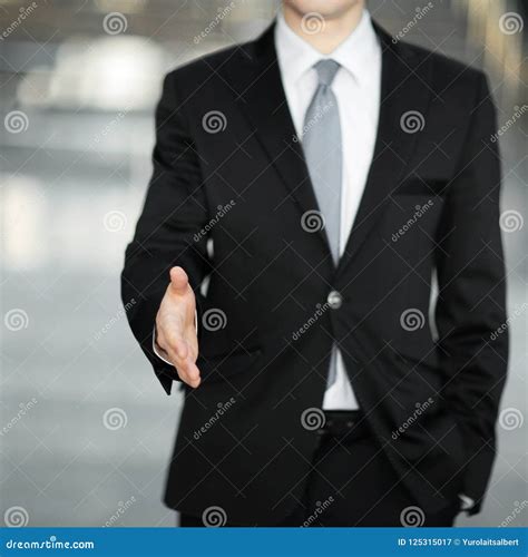 Handsome Businessman Holding Out Hand For A Handshake Stock Image