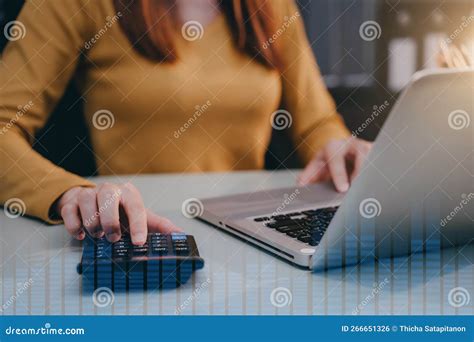 Female Working On Desk Office With Using A Calculator To Calculate Tax