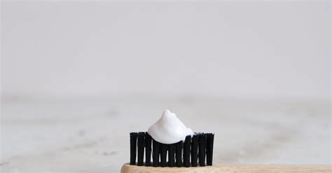 Toothpaste on a Bamboo Toothbrush · Free Stock Photo