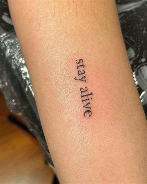 Stay Alive Lettering Tattoo Placed On The Inner Arm