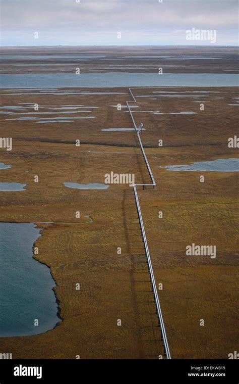 Aerial Of Oil Pipeline Threading Across Tundra Alpine Oil Field Near