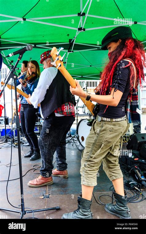 Side view, French folk rock band Triskelles performing on outdoor stage ...