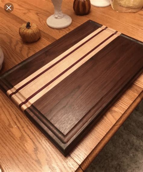 A Wooden Cutting Board Sitting On Top Of A Table