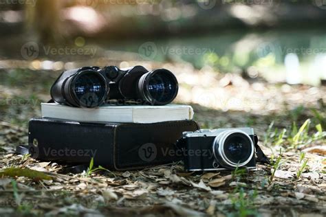 Binoculars, birdwatching guide book Camera and case laying on the ...