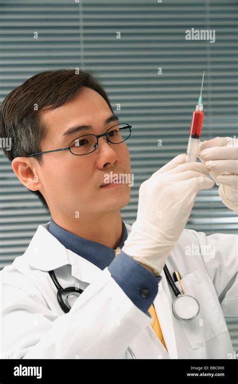 Doctor Preparing Hypodermic Needle Stock Photo Alamy