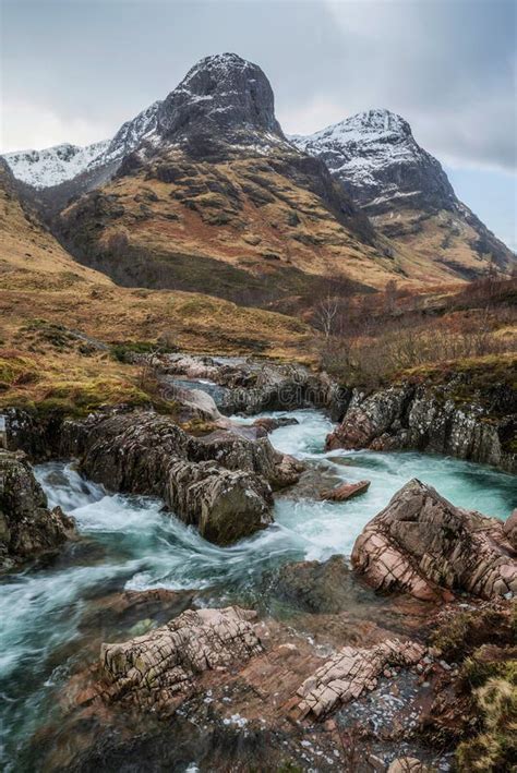 Epic Landscape Image Of Vibrant River Coe Flowing Beneath Snowcapped