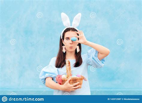 Woman Wearing Bunny Ears Holding Easter Basket Of Eggs Stock Image