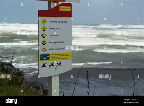 A Sign Warning Swimmers And Beach Goers Of Dangerous Hazards At Muriwai