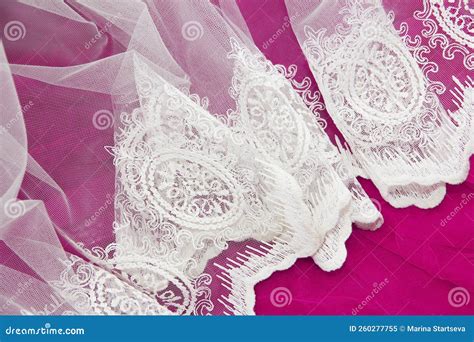 Texture Of White Lace Fabric With Floral Ornament On Pink Background